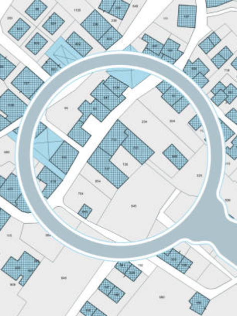 Imaginary cadastral map with buildings, land parcel and vacant plot - property registry and real estate concept seen through a magnifying glass