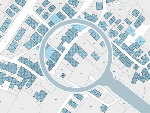 Imaginary cadastral map with buildings, land parcel and vacant plot - property registry and real estate concept seen through a magnifying glass